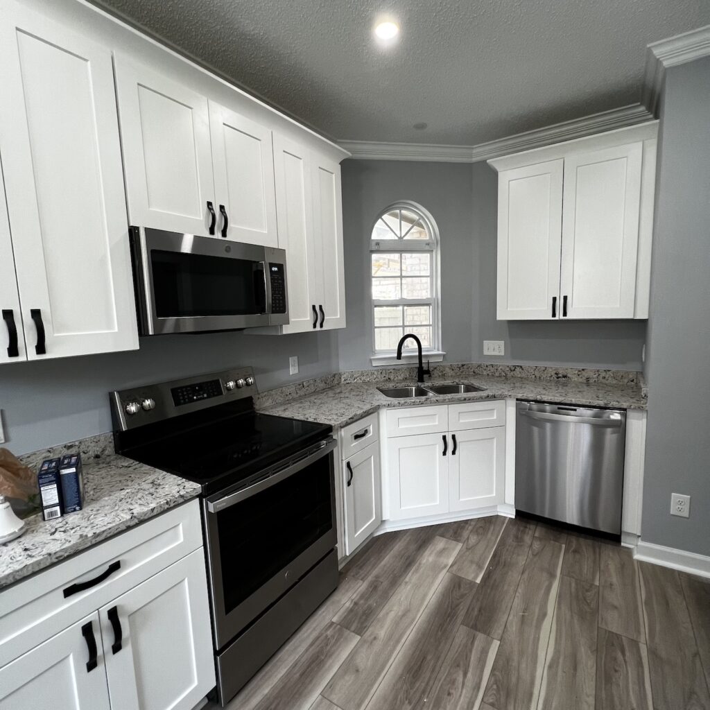 dark kitchen with white cabinets